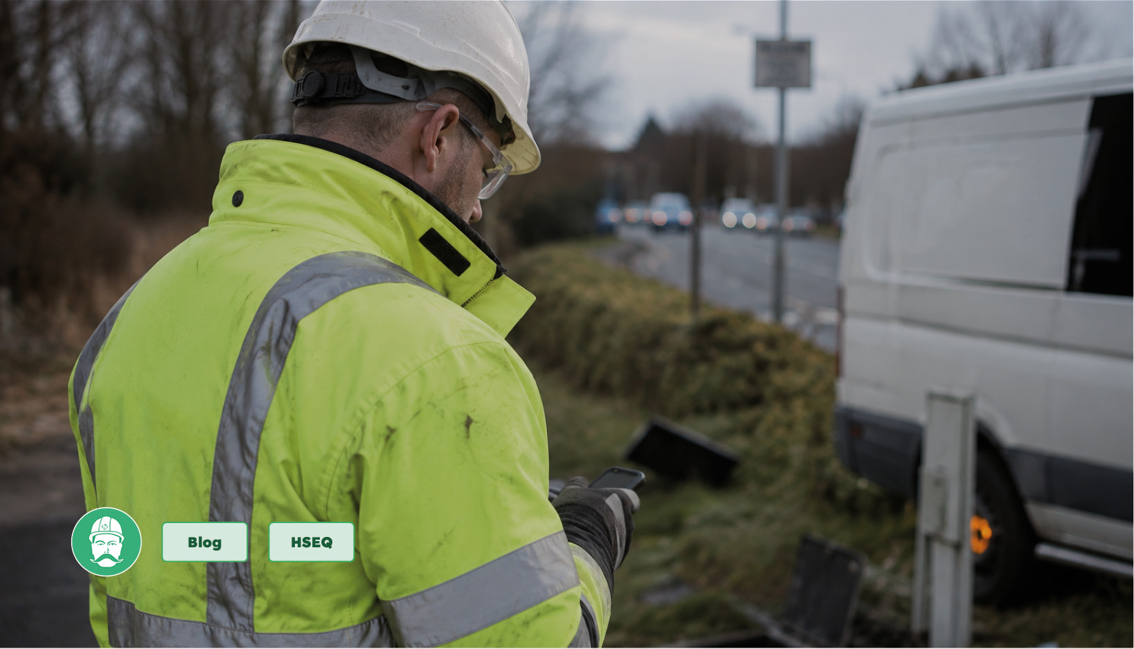 Field operative using a mobile device to record a health and safety incident during roadside utility works.
