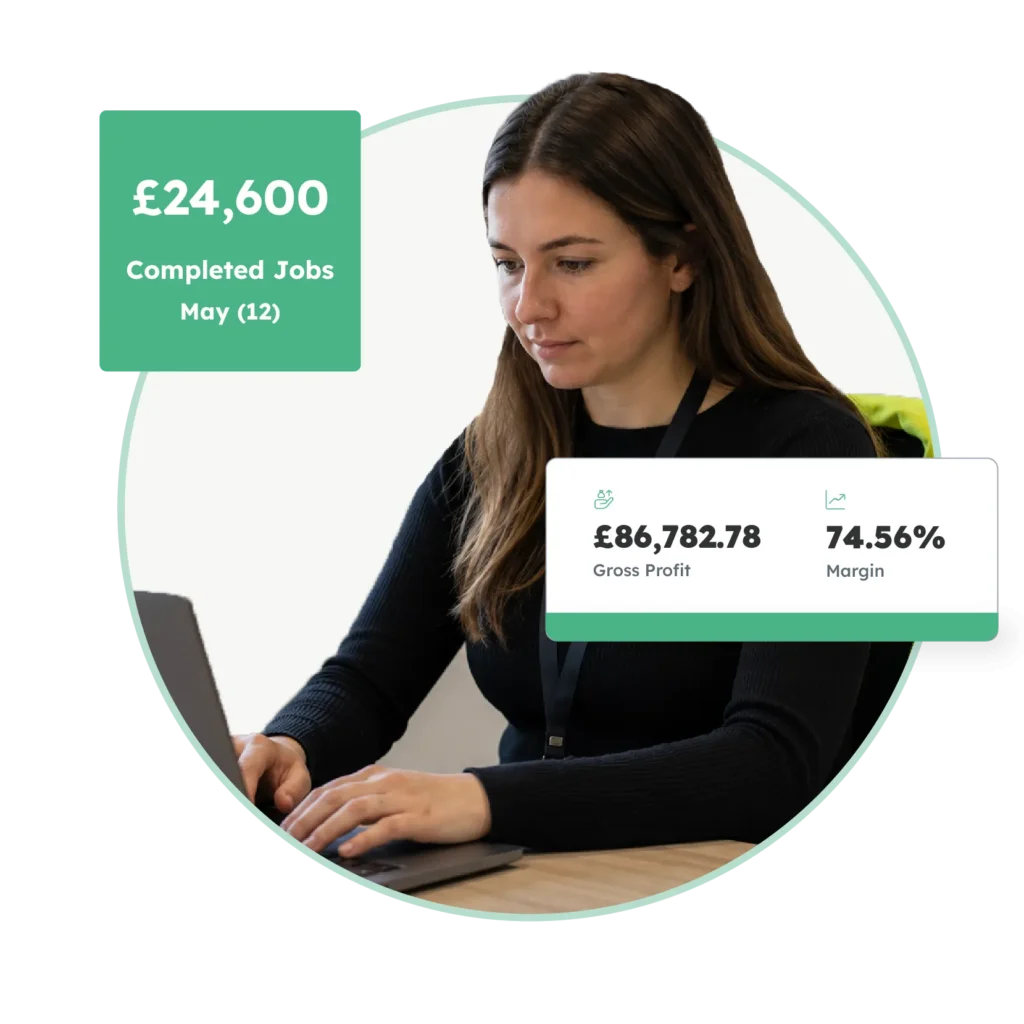 Commercial manager using commercial management software to monitor completed jobs, gross profit and margin.